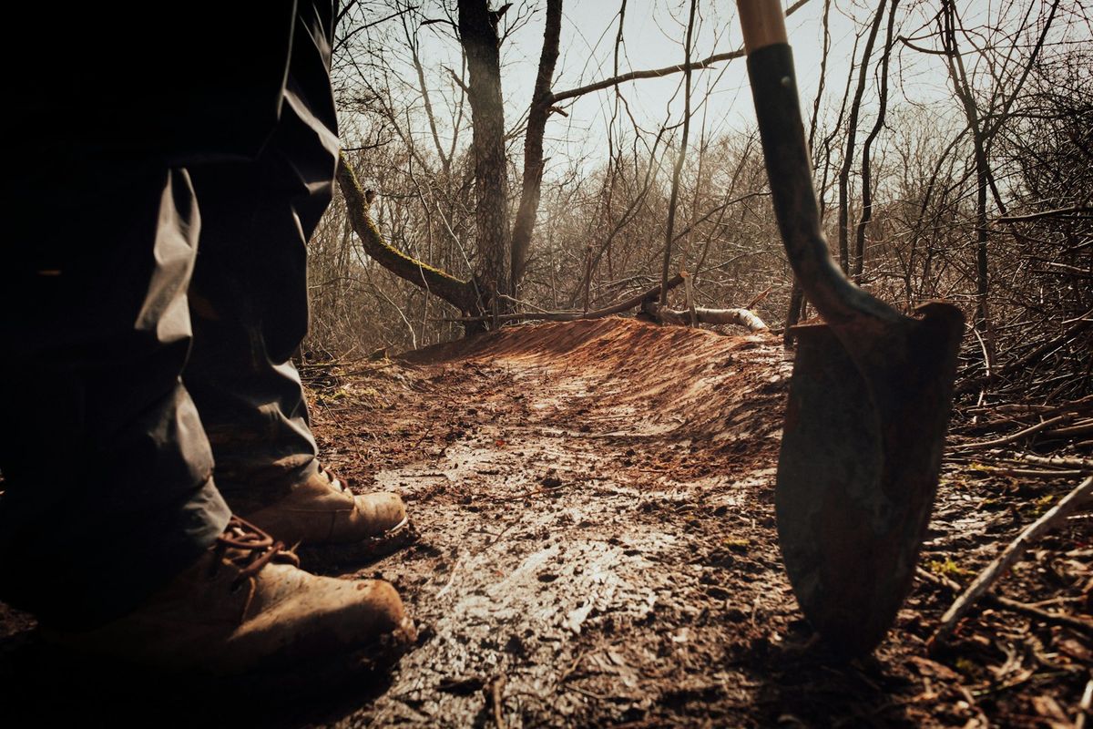 Work boots and a shovel in freshly dug ground